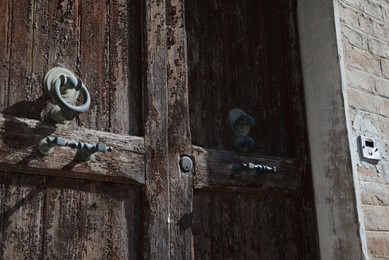 Photo of Closeup view of vintage wooden door outdoors