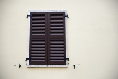 Beautiful building with window and wooden shutter