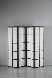 One folding screen near white wall indoors