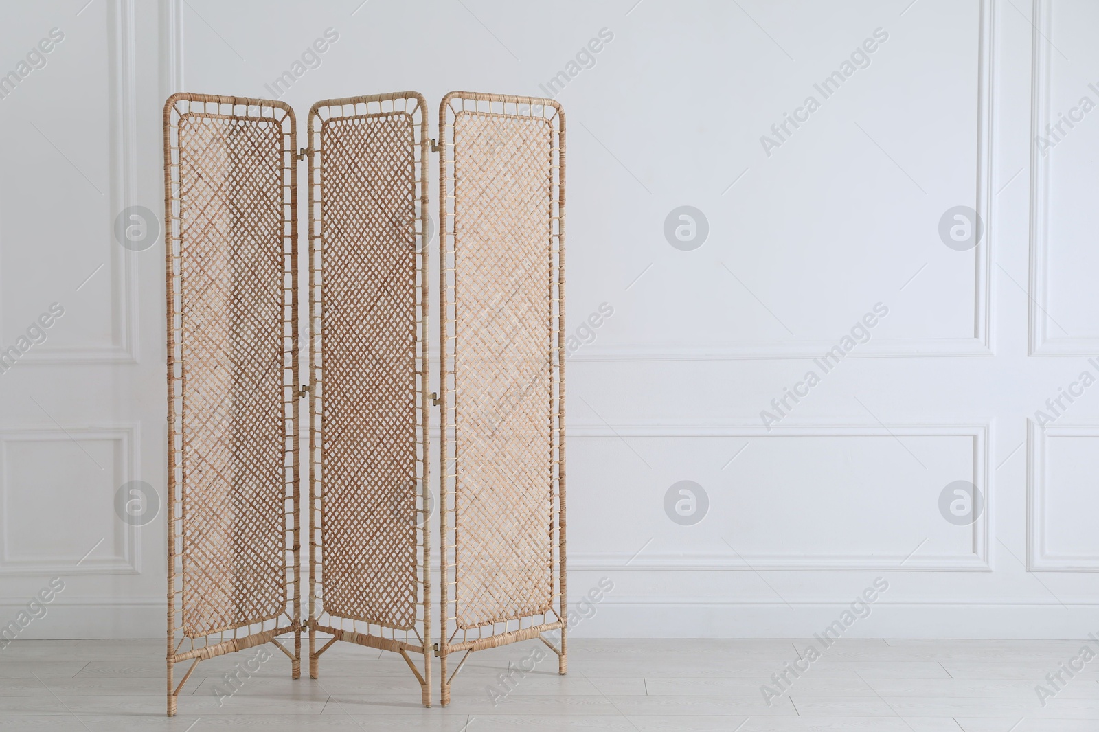 Photo of One folding screen near white wall indoors, space for text
