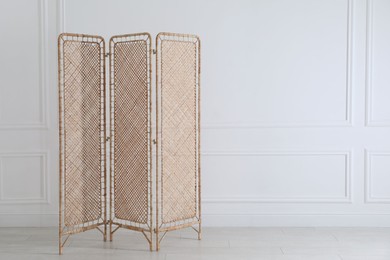 One folding screen near white wall indoors, space for text