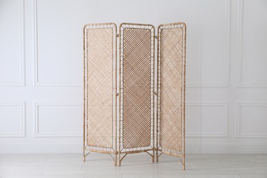 One folding screen near white wall indoors