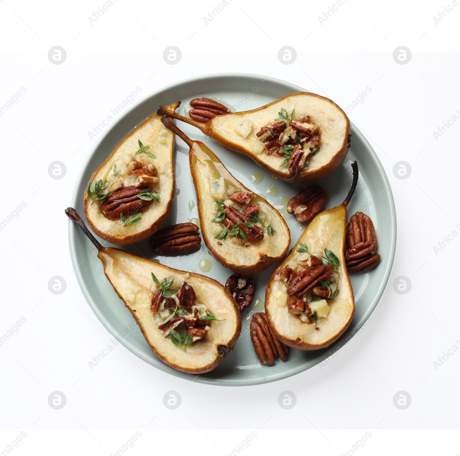 Photo of Tasty baked pears with nuts, blue cheese, thyme and honey on white background, top view