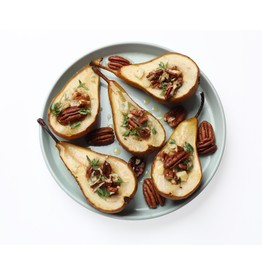 Tasty baked pears with nuts, blue cheese, thyme and honey on white background, top view