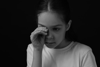 Photo of Portrait of sad girl in darkness, closeup. Black and white effect