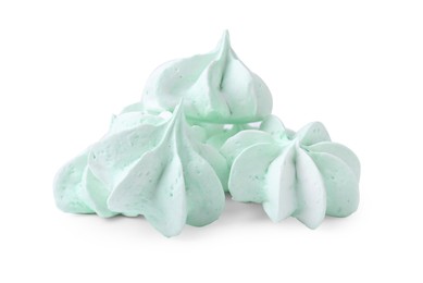 Photo of Many delicious meringue cookies isolated on white