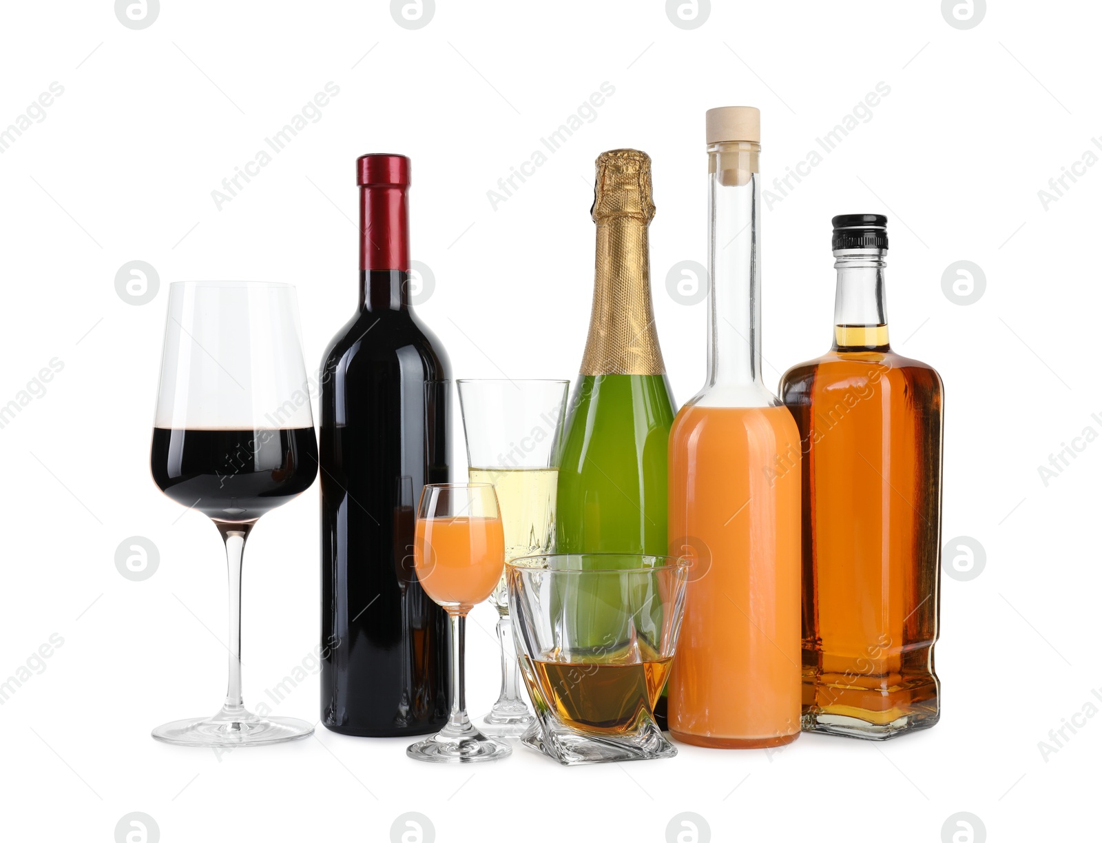 Photo of Bottles and glasses with different alcoholic drinks isolated on white