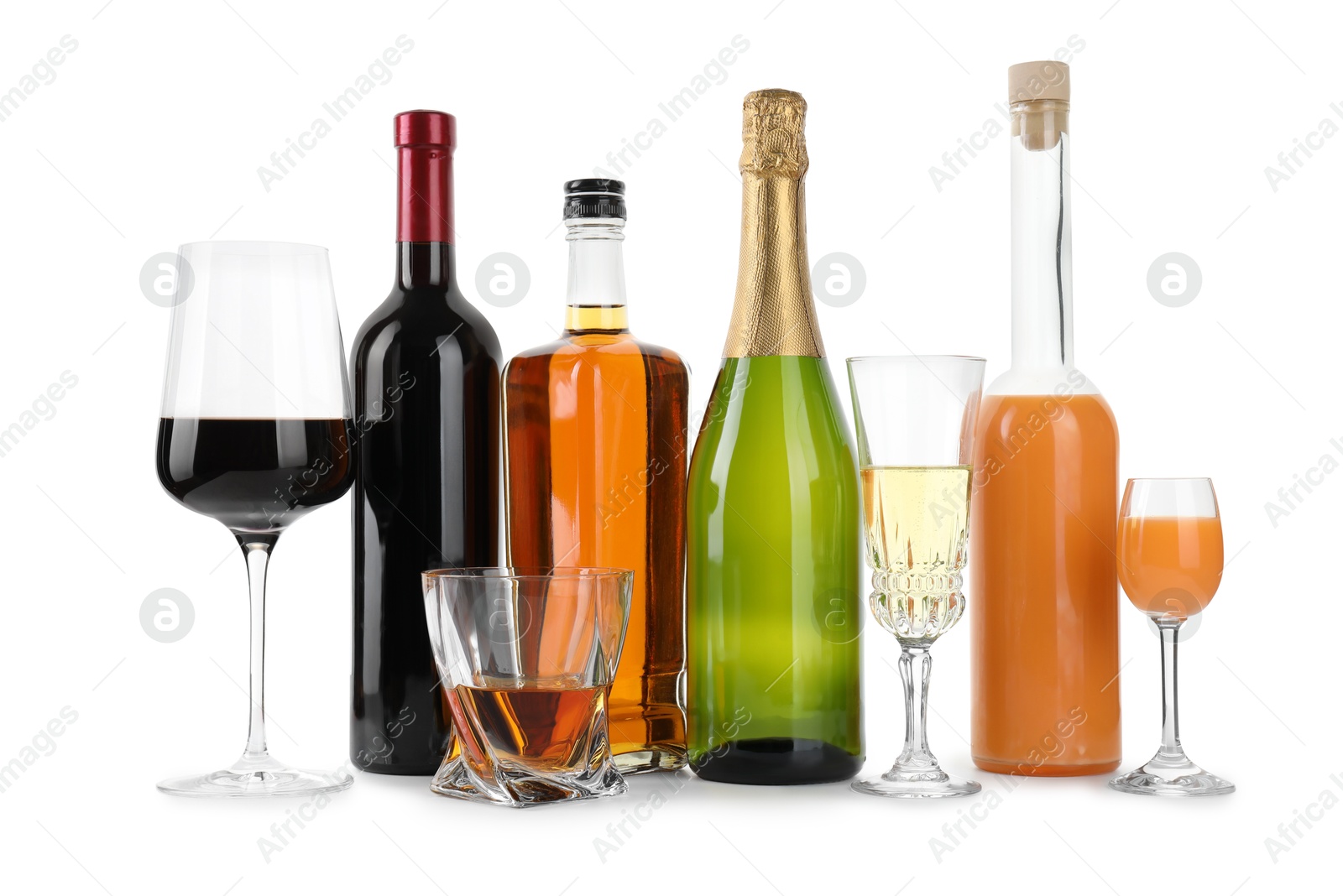 Photo of Bottles and glasses with different alcoholic drinks isolated on white