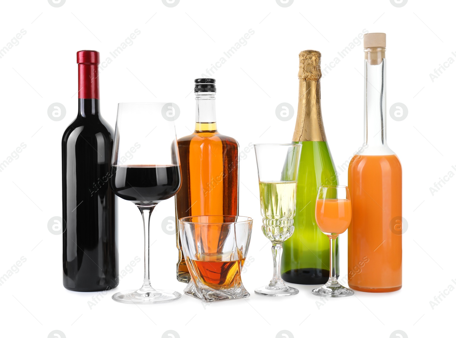 Photo of Bottles and glasses with different alcoholic drinks isolated on white