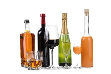 Bottles and glasses with different alcoholic drinks isolated on white