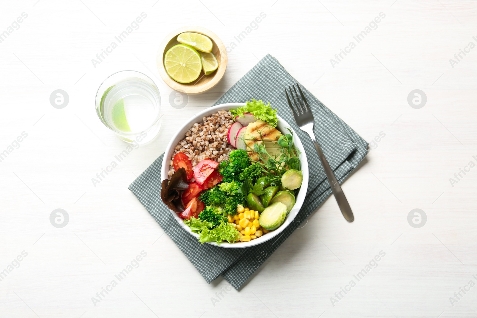 Photo of Healthy meal. Tasty products in bowl on white table, top view