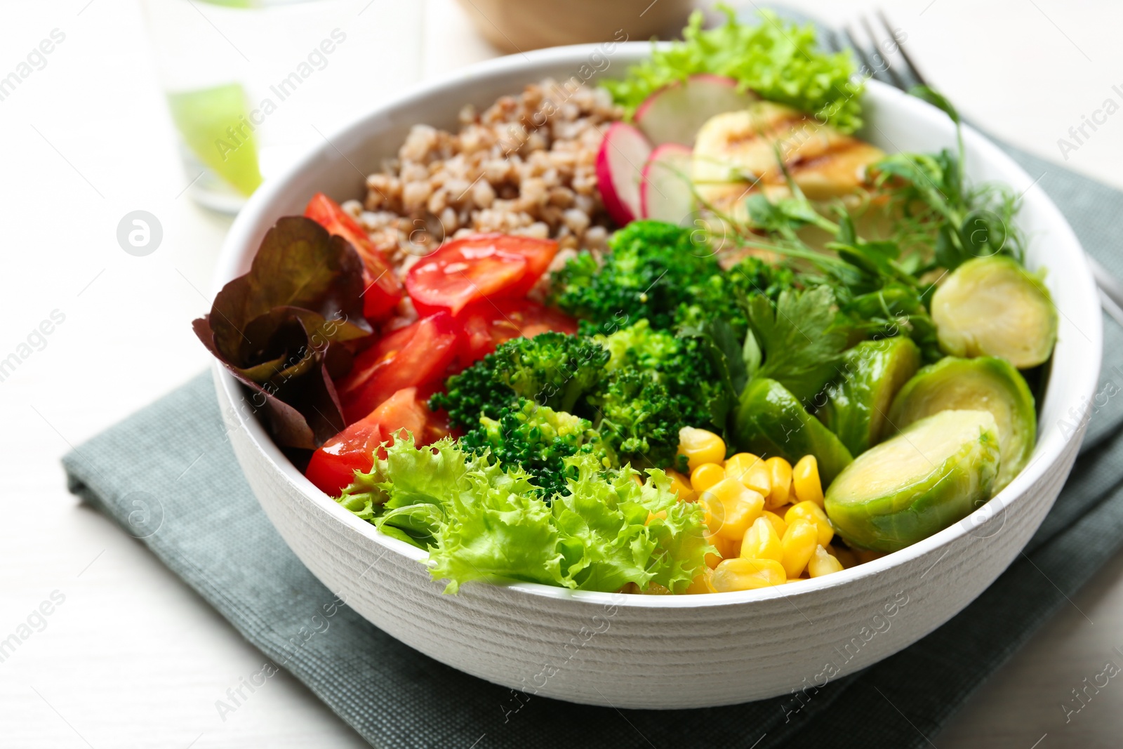 Photo of Healthy meal. Tasty products in bowl on white table, closeup