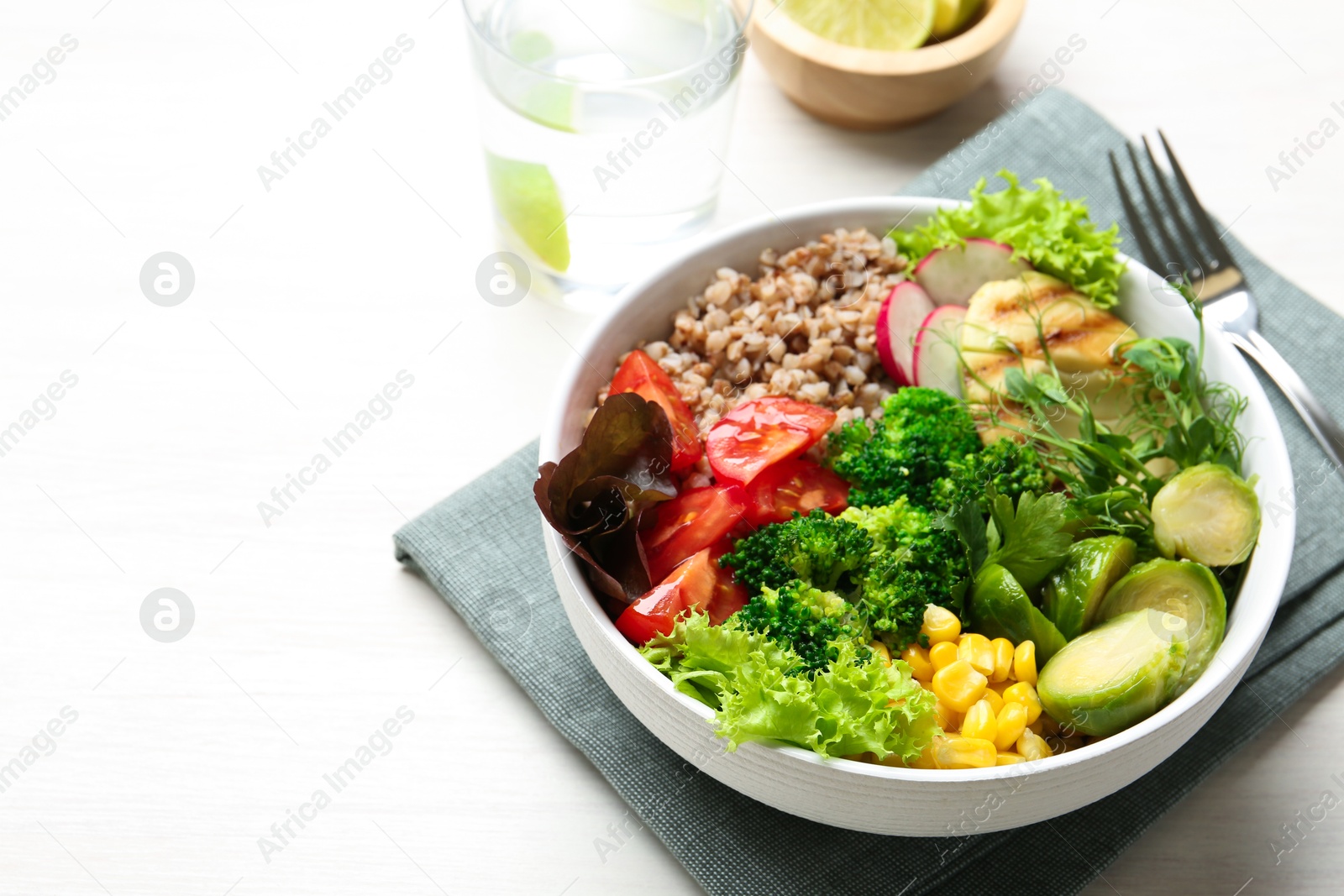 Photo of Healthy meal. Tasty products in bowl on white table, space for text