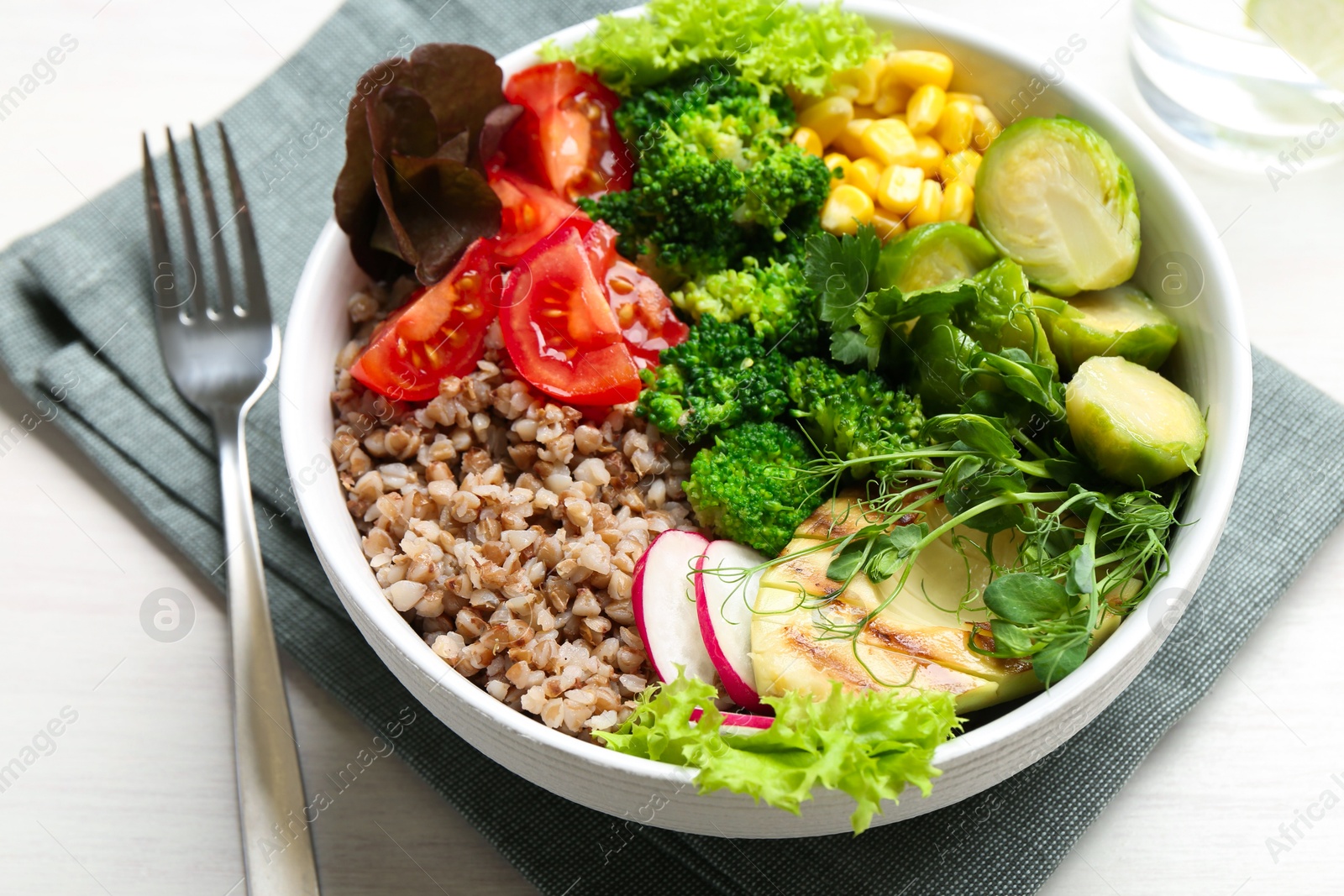 Photo of Healthy meal. Tasty products in bowl on white table, closeup