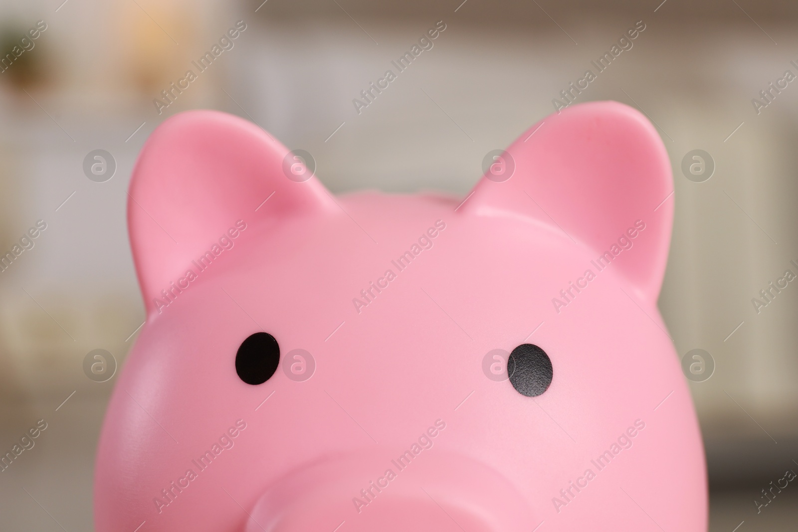 Photo of Pink piggy bank on blurred background, closeup