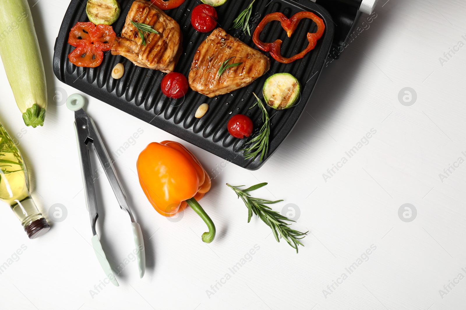 Photo of Flat lay composition with electric grill and different products on white table