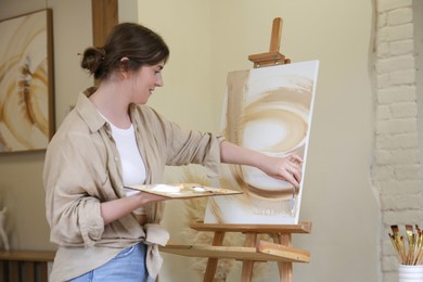 Photo of Woman with palette drawing picture in studio