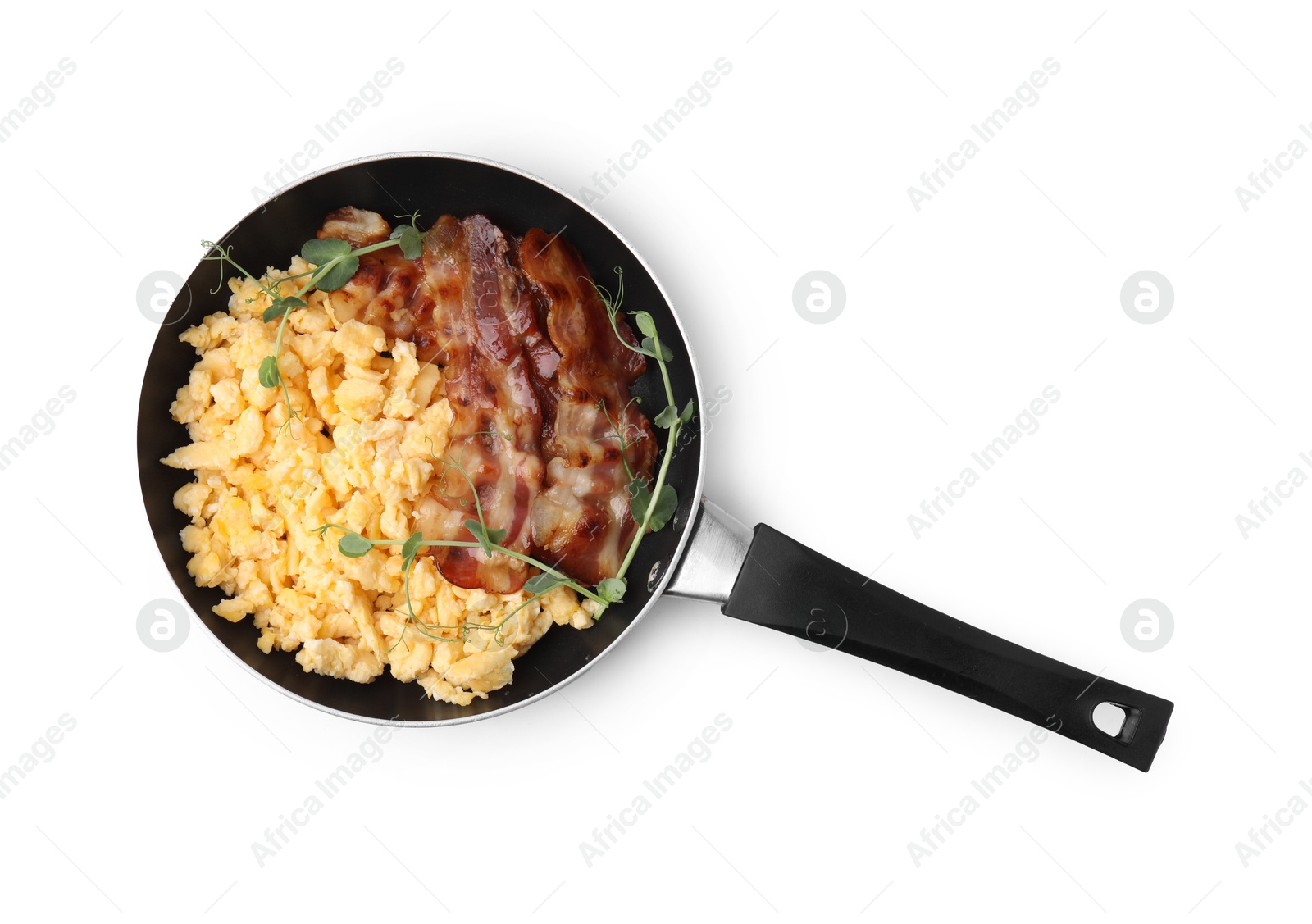 Photo of Delicious scrambled eggs with bacon in frying pan isolated on white, top view