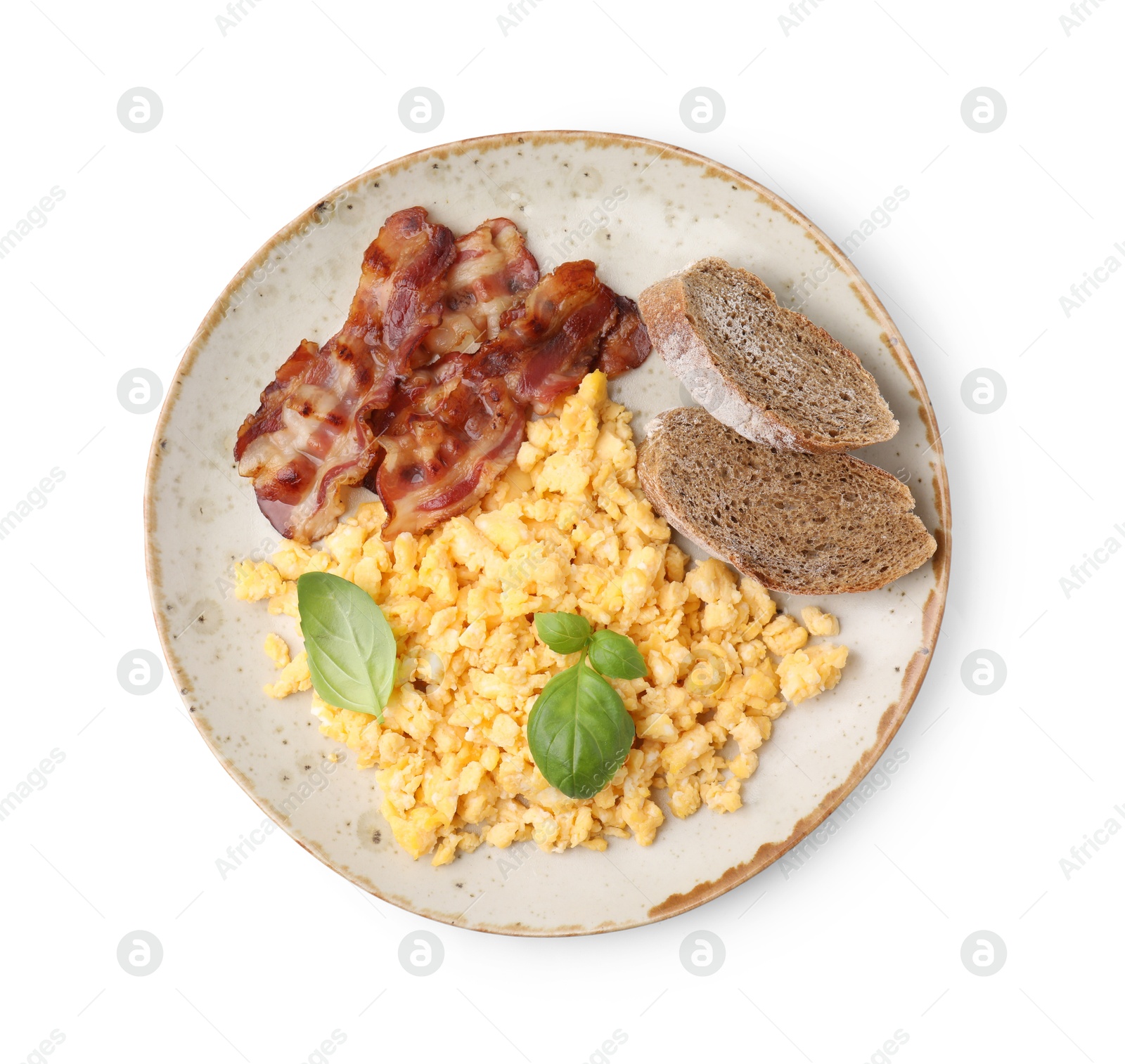 Photo of Delicious scrambled eggs with bacon and basil in plate isolated on white, top view