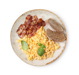 Delicious scrambled eggs with bacon and basil in plate isolated on white, top view