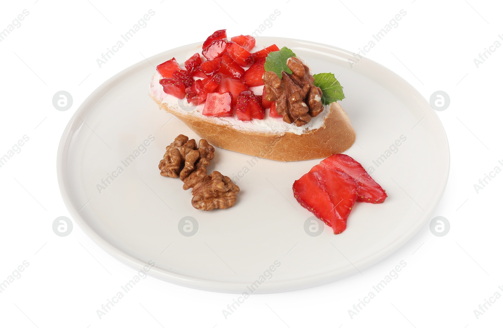 Photo of Delicious bruschetta with ricotta cheese, strawberries, mint and walnuts isolated on white