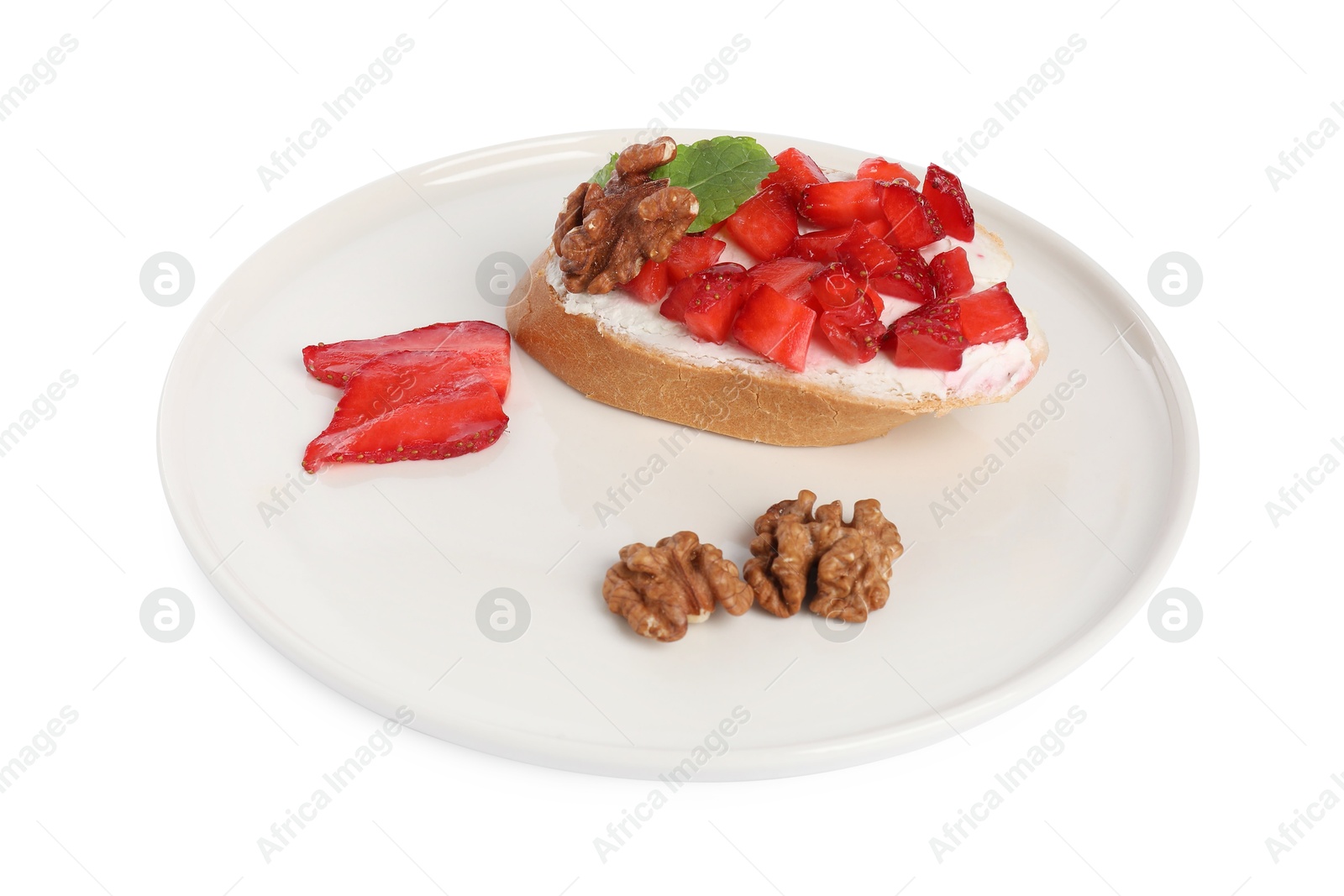 Photo of Delicious bruschetta with ricotta cheese, strawberries, mint and walnuts isolated on white