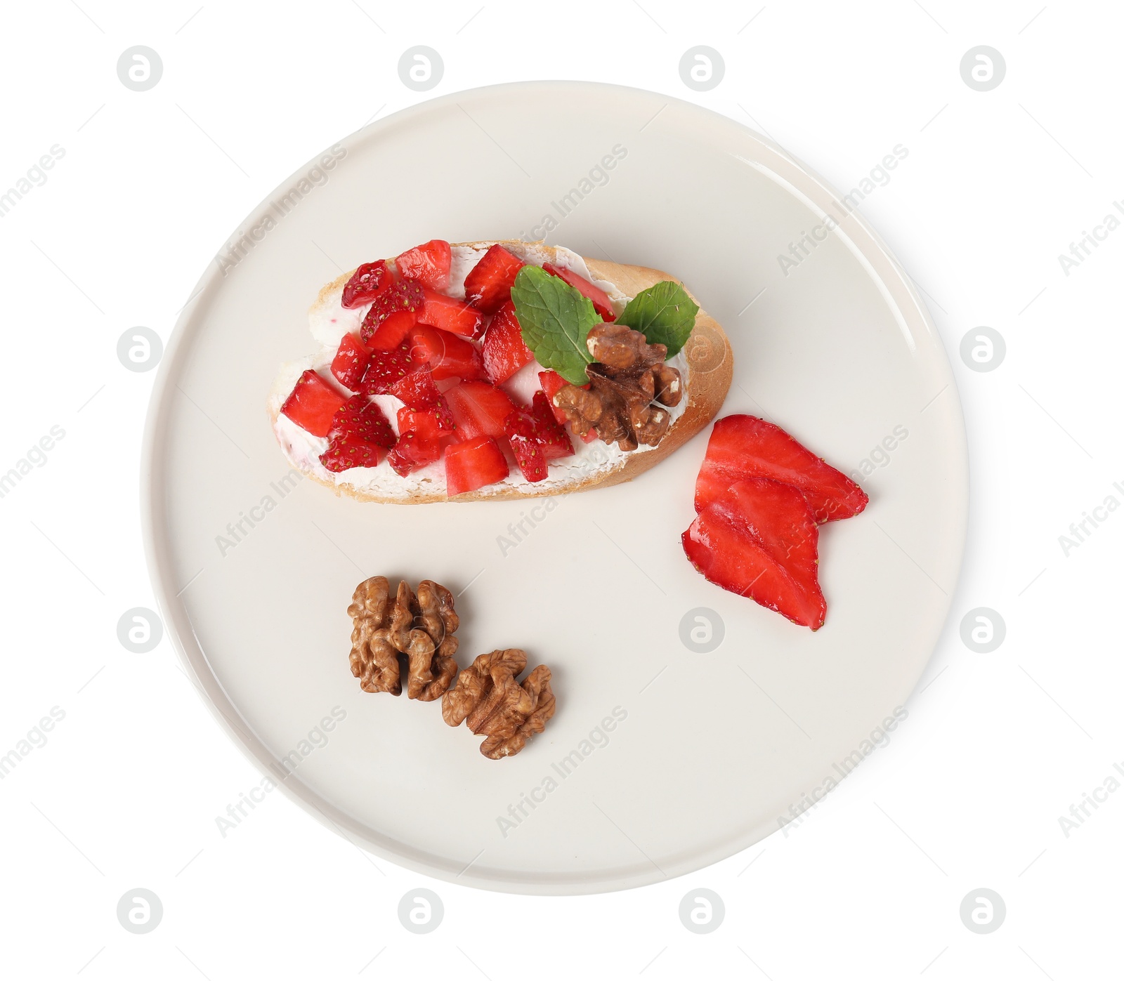 Photo of Delicious bruschetta with ricotta cheese, strawberries, mint and walnuts isolated on white, top view