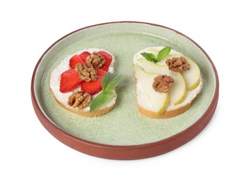 Delicious bruschettas with ricotta cheese, pear, strawberries, mint and walnuts isolated on white