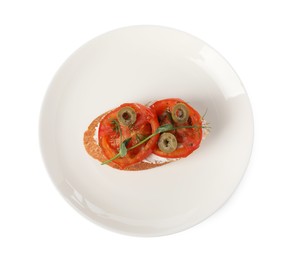 Delicious ricotta bruschetta with sliced tomatoes, olives and greens isolated on white, top view