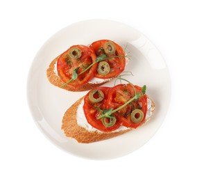 Delicious ricotta bruschettas with sliced tomatoes, olives and greens isolated on white, top view