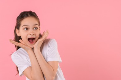 Photo of Portrait of emotional girl on pink background, space for text