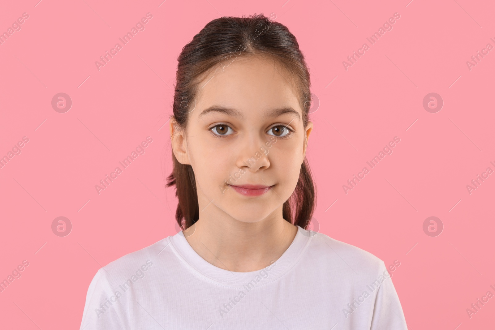 Photo of Portrait of beautiful girl on pink background