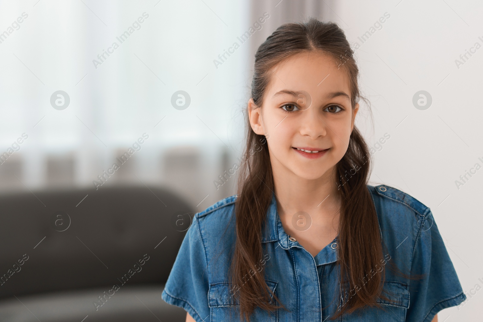 Photo of Portrait of beautiful little girl indoors, space for text