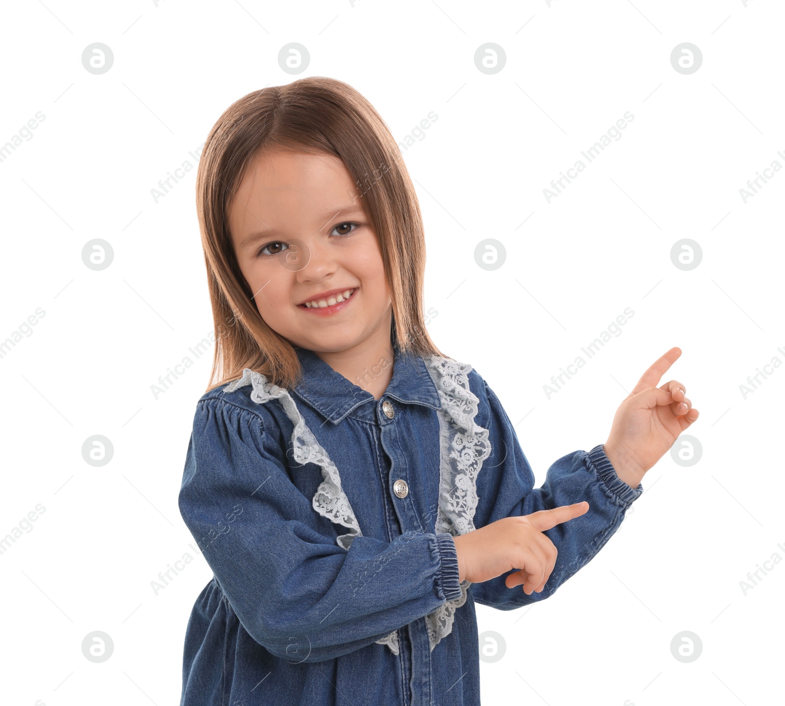 Photo of Portrait of happy little girl pointing at something on white background