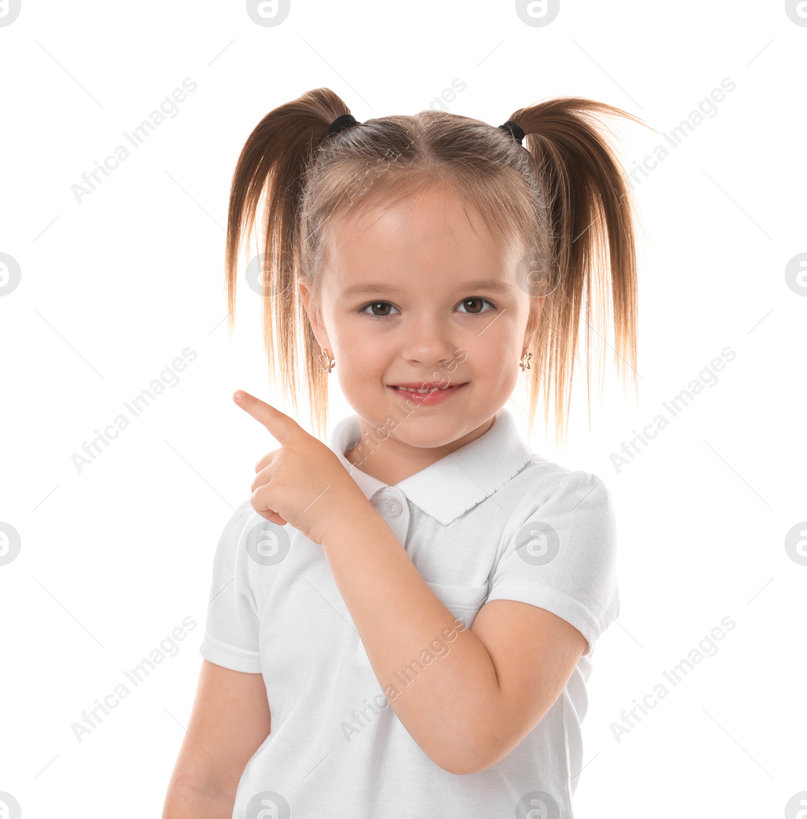 Photo of Portrait of cute little girl pointing at something on white background