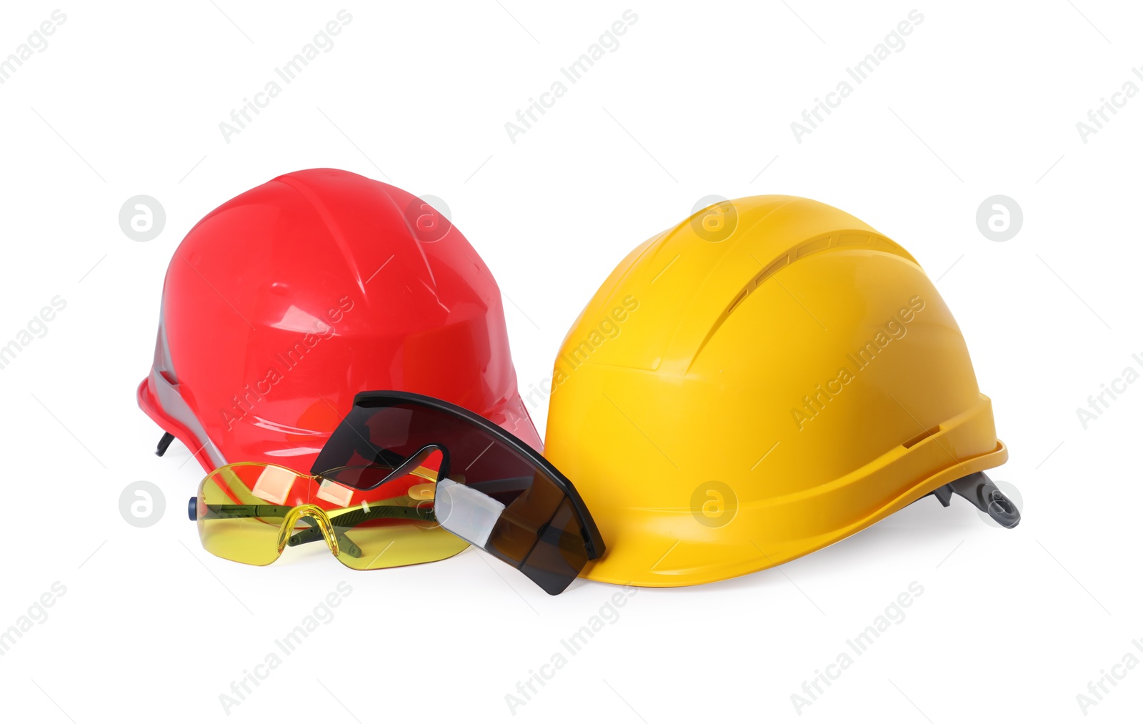 Photo of Hard hats and protective goggles isolated on white