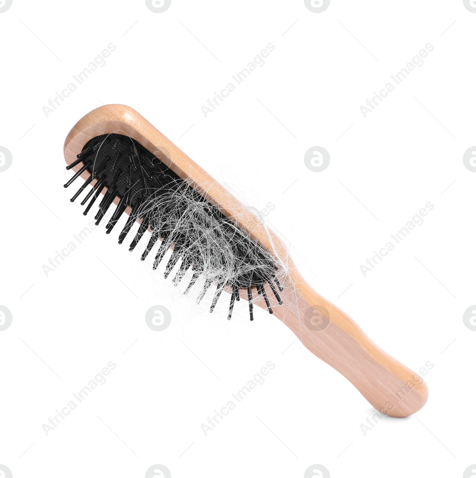 Photo of Wooden brush with lost hair in air on white background