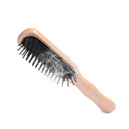 Photo of Wooden brush with lost hair in air on white background