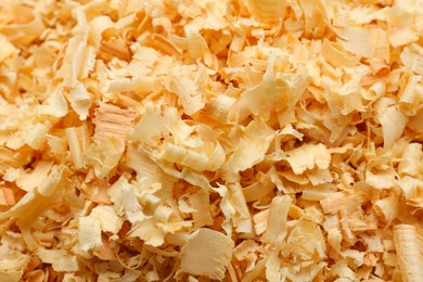 Photo of Dry natural sawdust as background, closeup view