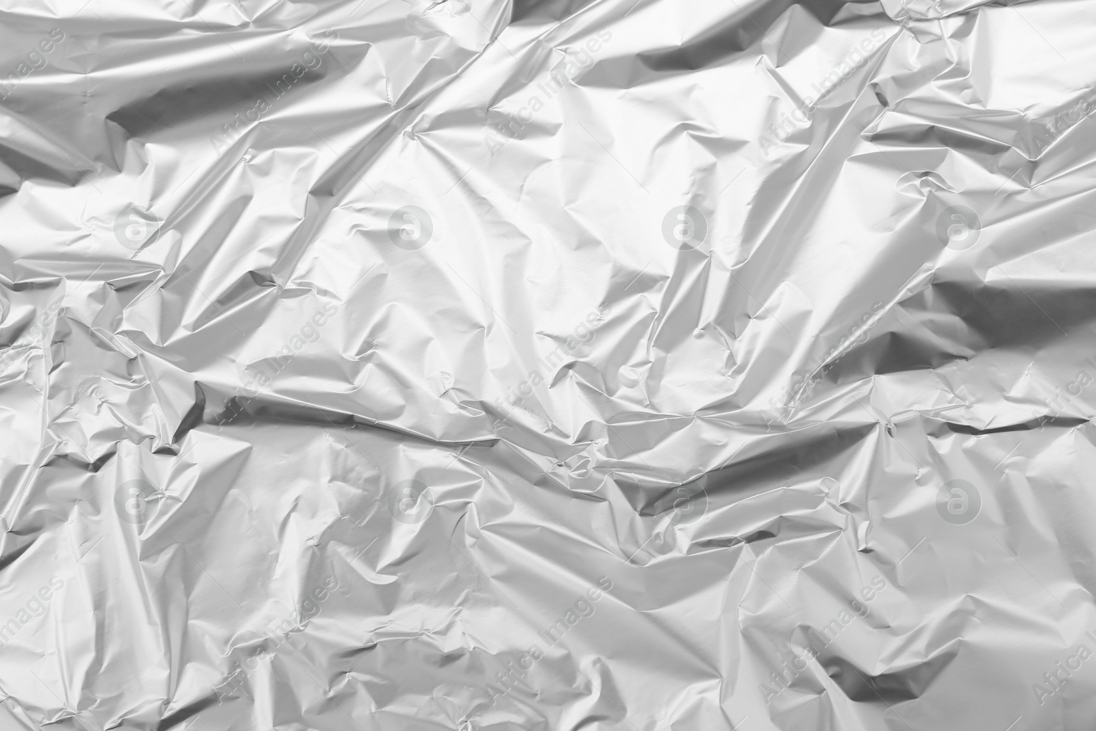 Photo of Crumpled silver foil as background, top view