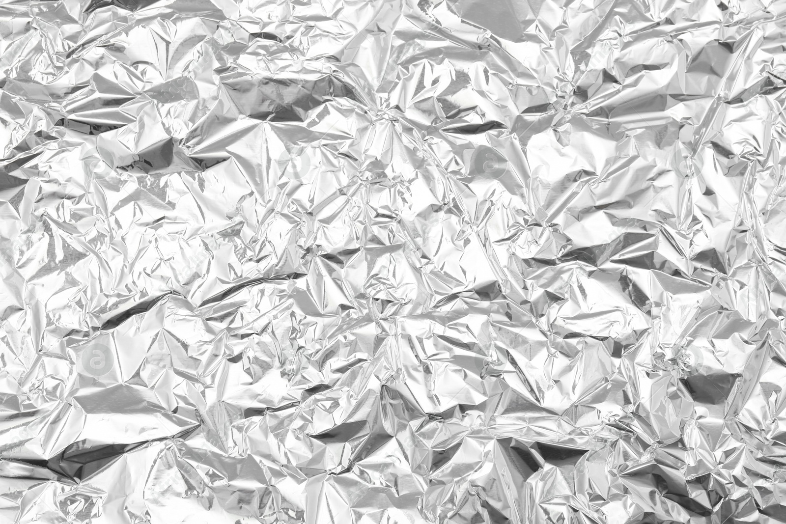 Photo of Crumpled silver foil as background, top view