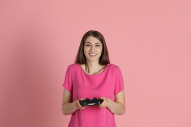 Photo of Happy woman with controller on pink background