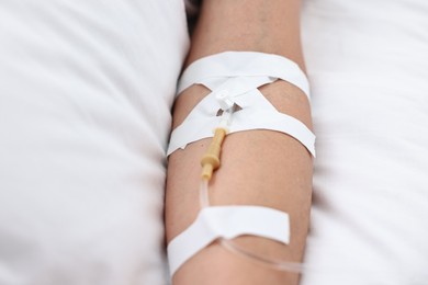 Photo of Woman with intravenous drip in hospital bed, closeup