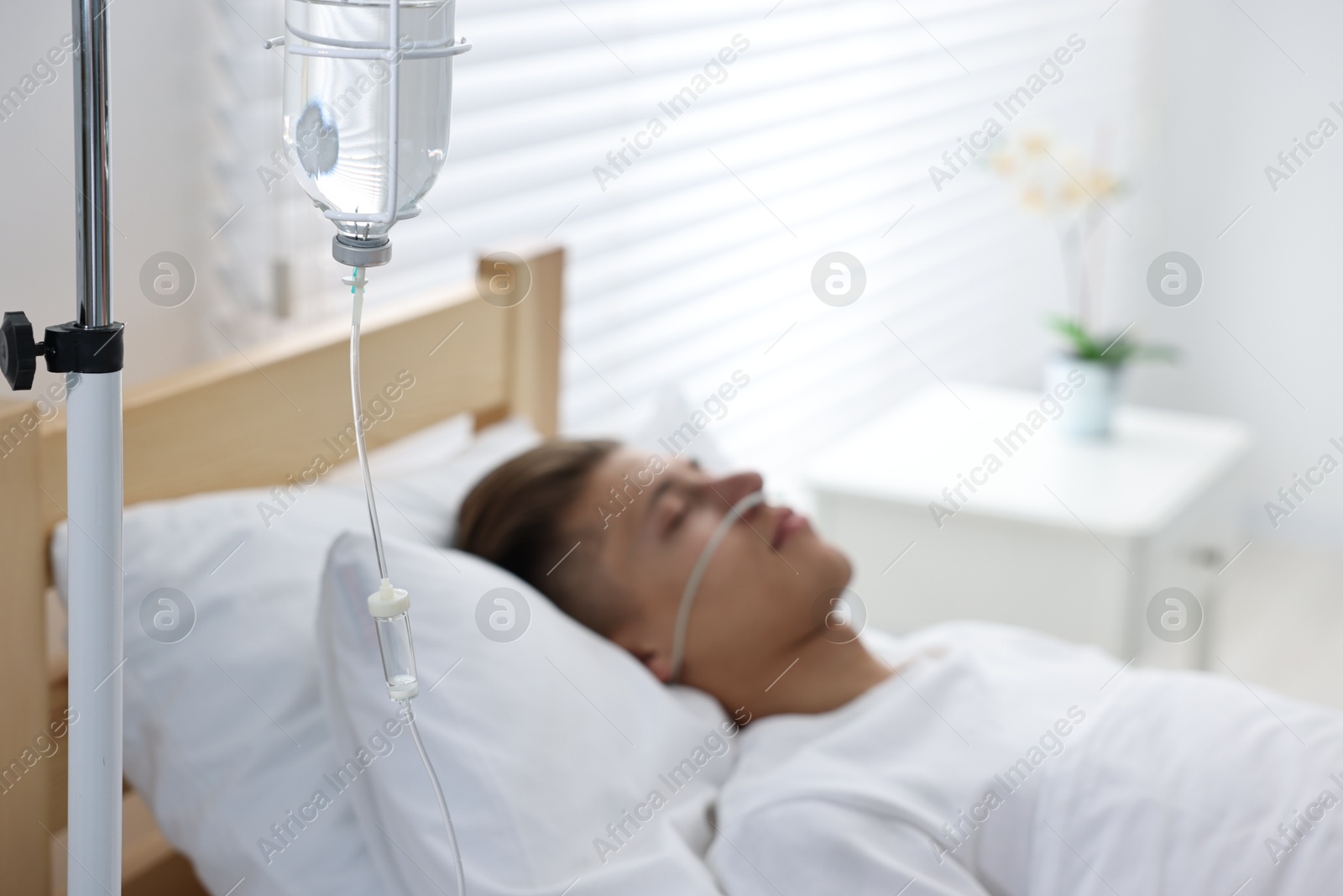 Photo of Coma patient. Young man sleeping in hospital bed