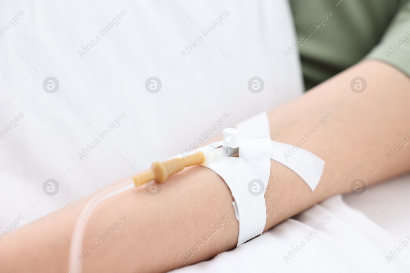 Photo of Woman with intravenous drip in hospital bed, closeup