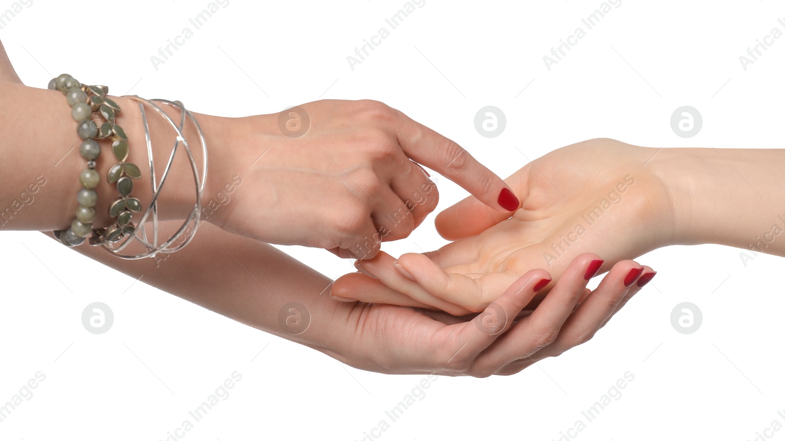 Photo of Fortune teller reading lines on woman's palm against white background. Chiromancy