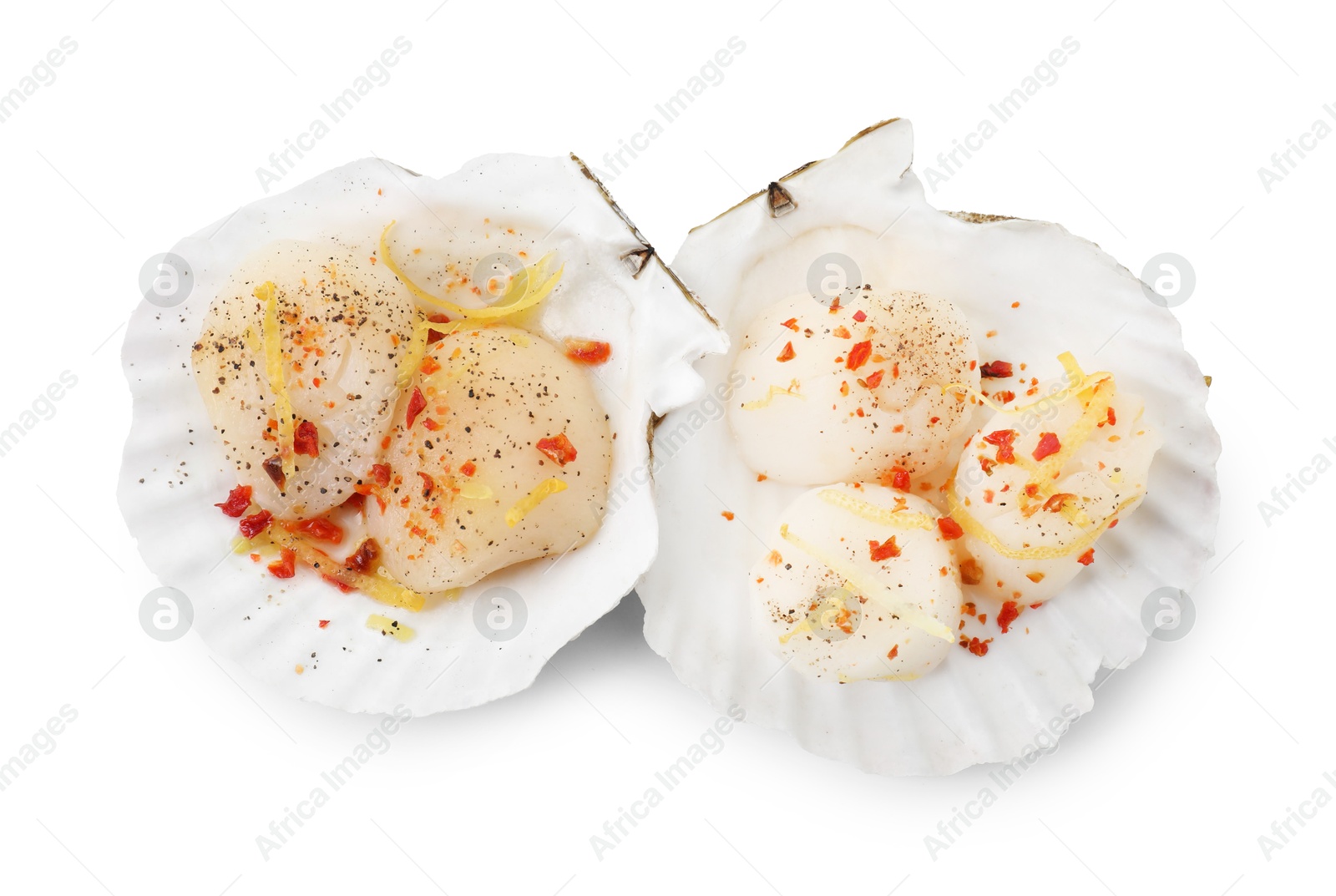 Photo of Raw scallops with lemon zest, spices and shell isolated on white, top view