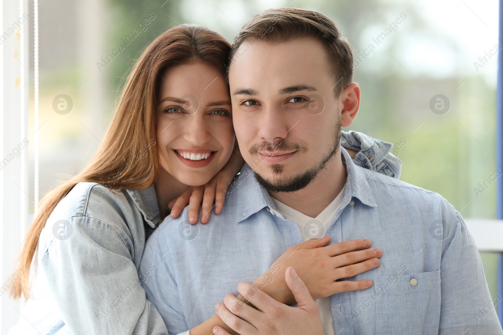 Photo of Family portrait of happy couple at home