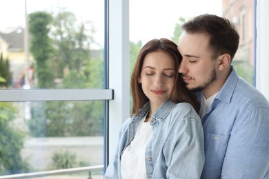 Cute couple enjoying each other at home. Space for text