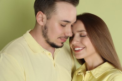 Photo of Happy couple on green background. Strong relationship